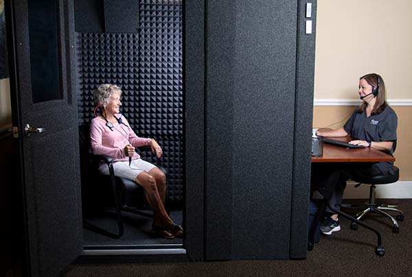 Patient and provider using the hearing booth for a hearing test
