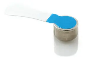A small, round silver battery with a blue and white pull tab attached, placed on a white surface.