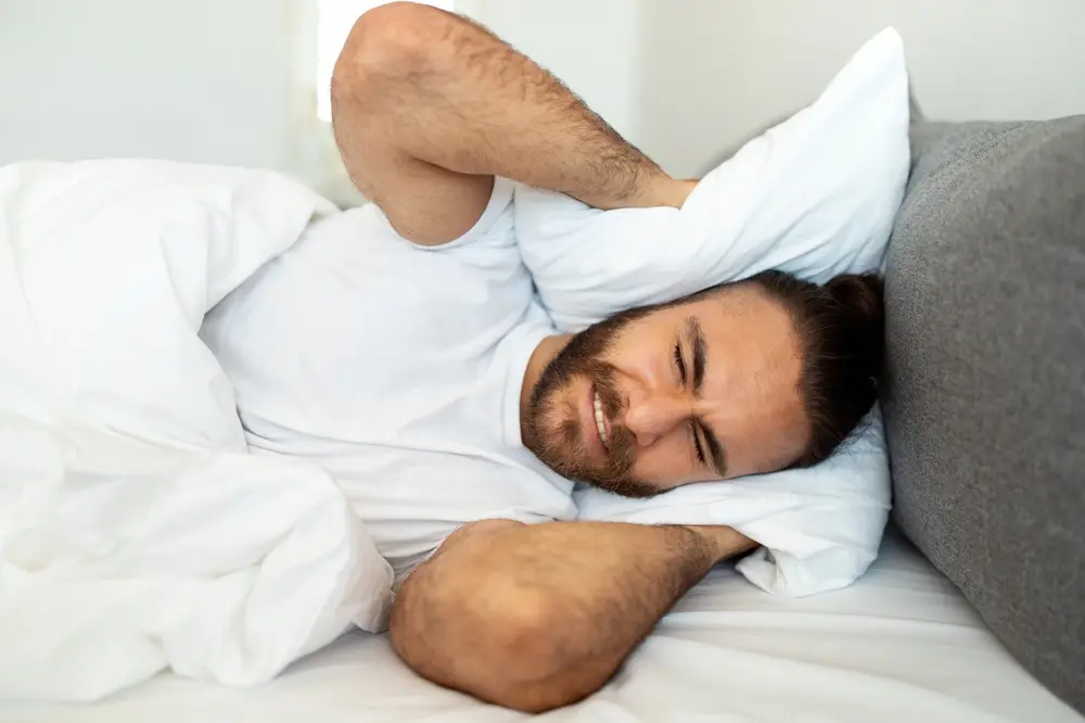 A man experiencing tinnitus or ear discomfort