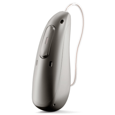 A close-up of a modern, sleek hearing aid device with a metallic finish and a thin, clear tube extending from the top.